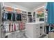 Well-organized walk-in closet with custom shelving and ample space for storage at 1938 Filly Trl, Oviedo, FL 32765