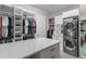 Large walk-in closet with a center island, custom shelving, and a washer/dryer at 1938 Filly Trl, Oviedo, FL 32765