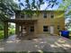 Two-story home with a covered back patio, spacious backyard, and lush greenery at 2020 Rushden Dr, Ocoee, FL 34761