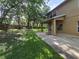 Spacious backyard with a covered patio, providing shade and an outdoor living space at 2020 Rushden Dr, Ocoee, FL 34761