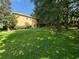 Spacious backyard features lush lawn and mature trees offering shade and privacy at 2020 Rushden Dr, Ocoee, FL 34761