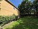 View of the home's exterior featuring a spacious lawn and mature trees at 2020 Rushden Dr, Ocoee, FL 34761