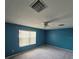 Large bedroom with neutral walls, ceiling fan, and natural light from the window at 2020 Rushden Dr, Ocoee, FL 34761