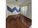 Dining Room with hard wood floors and modern accent wall at 2020 Rushden Dr, Ocoee, FL 34761