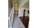 Bright foyer featuring staircase with white railing, tile flooring, and archway leading to living area at 2020 Rushden Dr, Ocoee, FL 34761