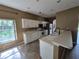 Well-lit kitchen featuring white cabinets, stainless steel appliances and tile floors at 2020 Rushden Dr, Ocoee, FL 34761