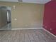 Open concept living room featuring tile flooring and a brightly painted accent wall at 2020 Rushden Dr, Ocoee, FL 34761