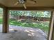 Covered patio area with view of backyard featuring mature landscaping and brick wall at 2020 Rushden Dr, Ocoee, FL 34761