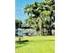 Backyard featuring green grass and a beautiful lake view with trees and dock at 204 Quayside Cir # 601, Maitland, FL 32751