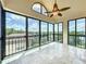 Enclosed balcony featuring large windows, tile floors and a ceiling fan at 204 Quayside Cir # 601, Maitland, FL 32751