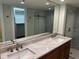 Bathroom featuring double sink vanity and glass-enclosed shower at 204 Quayside Cir # 601, Maitland, FL 32751