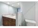 Bathroom with a dark wood vanity, marble countertop, and a large mirror at 204 Quayside Cir # 601, Maitland, FL 32751