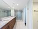 Modern bathroom boasts double sinks with marble countertop and glass shower with mosaic tiles at 204 Quayside Cir # 601, Maitland, FL 32751