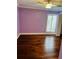 Bedroom with wooden floor, ceiling fan, and large window with blinds at 204 Quayside Cir # 601, Maitland, FL 32751