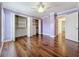 Bedroom showcases hardwood floors, ceiling fan, closet space and en-suite bathroom access at 204 Quayside Cir # 601, Maitland, FL 32751