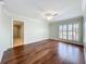 Bedroom featuring hardwood floors, a ceiling fan and an ensuite bath with shower at 204 Quayside Cir # 601, Maitland, FL 32751