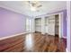 Light-filled bedroom featuring hardwood floors, a ceiling fan, and plenty of closet space at 204 Quayside Cir # 601, Maitland, FL 32751