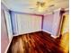 Bedroom with wooden floor, ceiling fan, and large window with blinds at 204 Quayside Cir # 601, Maitland, FL 32751