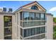 Condo exterior showing multiple enclosed balconies and a red tile roof at 204 Quayside Cir # 601, Maitland, FL 32751