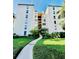 Exterior view of high-rise condo building featuring green landscaping at 204 Quayside Cir # 601, Maitland, FL 32751