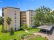 Attractive multi-story condo building showcasing well-manicured landscaping and convenient covered parking at 204 Quayside Cir # 601, Maitland, FL 32751