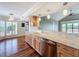 Elegant kitchen featuring hardwood floors, granite countertops, and modern stainless steel appliances at 204 Quayside Cir # 601, Maitland, FL 32751