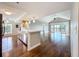 Stylish kitchen and open living space with wood floors, granite counters, and a ceiling fan at 204 Quayside Cir # 601, Maitland, FL 32751