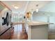 Spacious kitchen featuring wood floors, stainless steel appliances, and a large marble island at 204 Quayside Cir # 601, Maitland, FL 32751