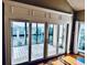 Living room with vaulted ceiling, fan, and sliding glass doors to a balcony at 204 Quayside Cir # 601, Maitland, FL 32751