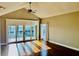 Living room with vaulted ceiling, ceiling fan and sliding glass doors at 204 Quayside Cir # 601, Maitland, FL 32751