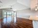 Large living room with high ceiling, hardwood floors, and sliding glass doors to balcony at 204 Quayside Cir # 601, Maitland, FL 32751