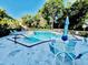 Resort style pool with lounge chairs, tables, umbrellas, and beautiful landscaping at 204 Quayside Cir # 601, Maitland, FL 32751