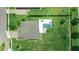An aerial of a house with a backyard pool, surrounded by green grass and well-kept hedges at 2118 Whiting Trl, Orlando, FL 32820