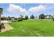 Expansive backyard featuring lush green grass, outdoor furniture, and a white fence at 2118 Whiting Trl, Orlando, FL 32820