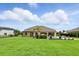Expansive backyard with well-maintained lawn, outdoor lounge furniture and patio area at 2118 Whiting Trl, Orlando, FL 32820