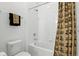 Clean bathroom features a shower with a UCF themed shower curtain and towel racks at 2118 Whiting Trl, Orlando, FL 32820