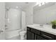Bright bathroom featuring a shower-tub combo, a vanity with a large mirror, and a fresh plant accent at 2118 Whiting Trl, Orlando, FL 32820