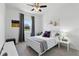 Bright bedroom showcases a ceiling fan, window with curtains, and a comfortable bed with decorative pillows at 2118 Whiting Trl, Orlando, FL 32820