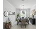 Bright dining room with modern chandelier, stylish furniture, and natural light at 2118 Whiting Trl, Orlando, FL 32820