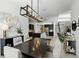 Open concept dining room with modern light fixture and access to kitchen at 2118 Whiting Trl, Orlando, FL 32820