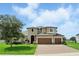 Beautiful two-story home with three-car garage, landscaped yard and brick paver driveway at 2118 Whiting Trl, Orlando, FL 32820