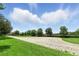 An expansive field with trees and blue skies in this landscaped community at 2118 Whiting Trl, Orlando, FL 32820