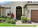 Inviting front entrance with colorful landscaping and a dark brown double door at 2118 Whiting Trl, Orlando, FL 32820
