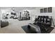 Spacious home gym is equipped with cardio machines, weightlifting equipment, and ample space for workouts at 2118 Whiting Trl, Orlando, FL 32820