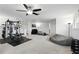 Large home gym featuring extensive workout equipment and plenty of space for activities at 2118 Whiting Trl, Orlando, FL 32820