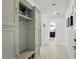 Hallway with built-in storage and seating showcasing an open view into the well-appointed kitchen area at 2118 Whiting Trl, Orlando, FL 32820
