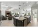 Modern kitchen island overlooking the open-concept living area and backyard at 2118 Whiting Trl, Orlando, FL 32820