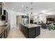 Open kitchen with large island, stainless appliances, and views into the living area at 2118 Whiting Trl, Orlando, FL 32820