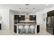 Open-concept kitchen featuring a large island with seating and modern pendant lighting at 2118 Whiting Trl, Orlando, FL 32820