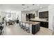 Modern kitchen with a large island, granite countertops, stainless steel appliances, and dining area at 2118 Whiting Trl, Orlando, FL 32820